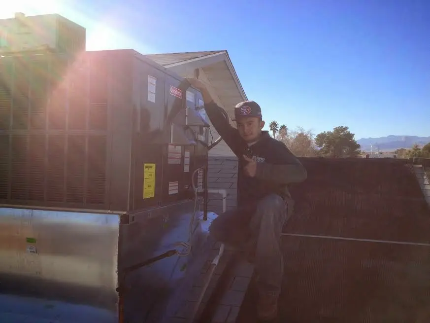 HVAC technician performing AC Tune-Up on a rooftop unit in Pinellas Park